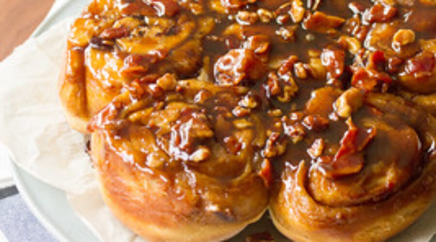 A close-up of a sticky bun with rich icing dripping down its caramelized sides, symbolizing indulgence and emotional eating. This image represents the temptation of comfort foods and how hypnosis can help manage cravings and emotional eating habits.